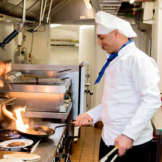 Alexis Estates chef cooking meal in kitchen