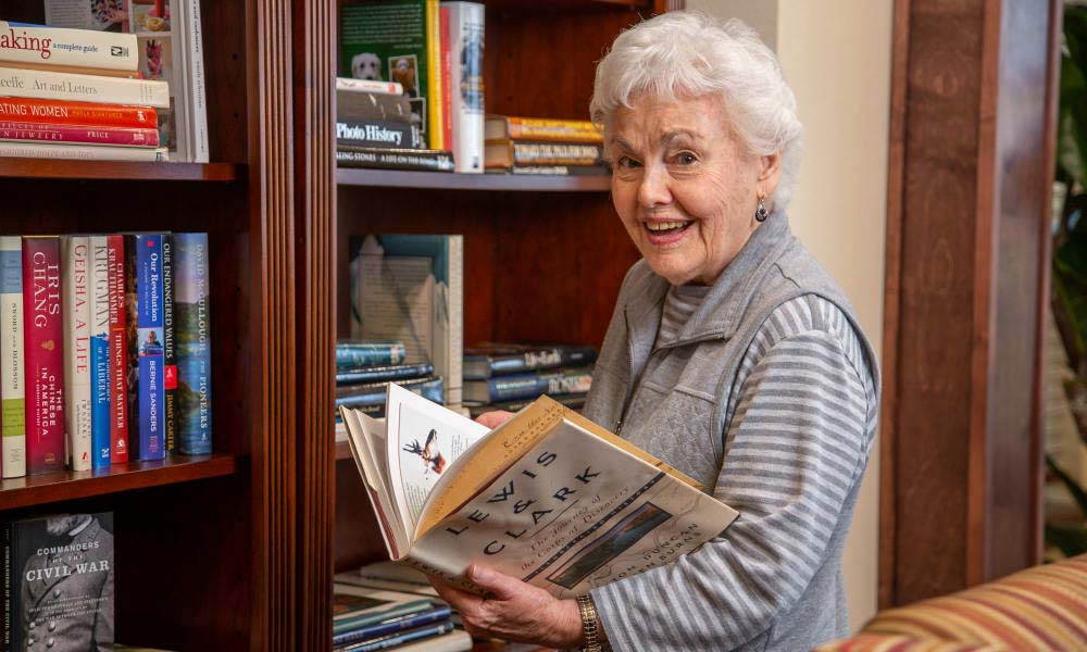Independent senior near Richardson selecting a book