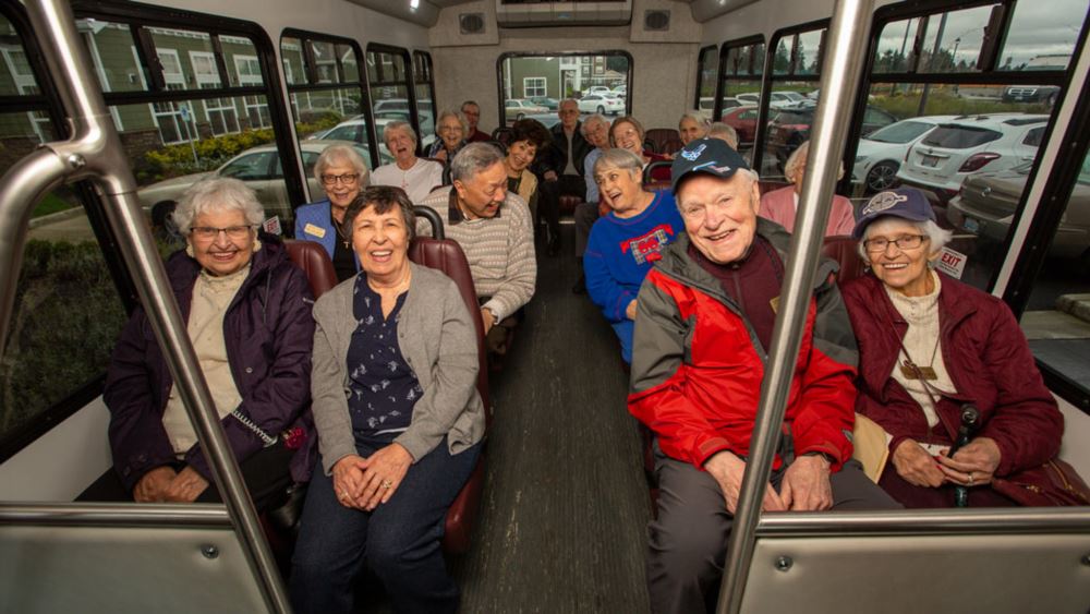 Alexis Estates happy seniors on a bus.