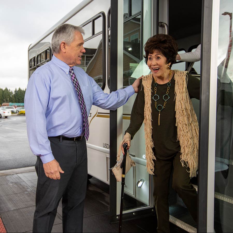 Alexis Estates helping lady off bus
